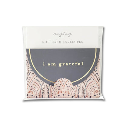 A pack of Maylay Co.'s "So Delicate" 6-pack gift card envelopes, featuring a sophisticated gold foil design. The front envelope showcases elegant pink and gold patterns with "I am grateful" highlighted in gold lettering on a dark semicircle, all expertly crafted with a high-quality matte finish.