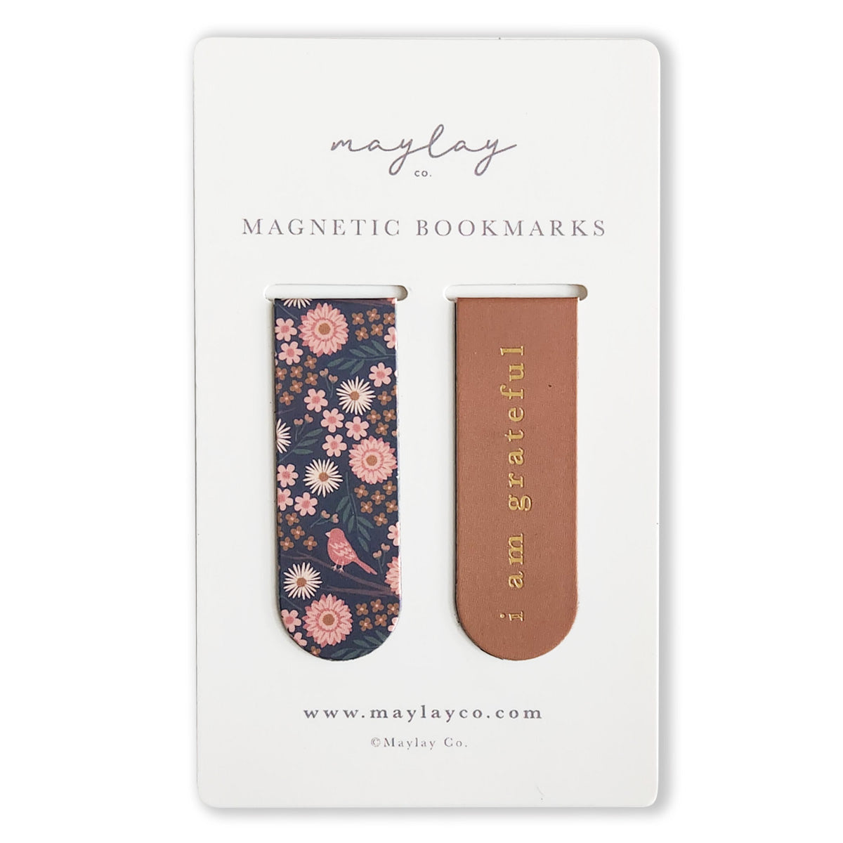 The Birdy Floral Magnetic Bookmarks (Set of 2) from Maylay Co. include two charming magnetic bookmarks on a card: one adorned with a dark floral and bird pattern, the other featuring a brown design with "i am grateful" in gold text. These perfect reading companions make thoughtful gifts, packaged on a card stating "Maylay Co." at both the top and bottom.