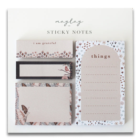 Introducing the Florals Mini Sticky Notes by Maylay Co., a charming set adorned with delicate floral patterns and butterfly motifs. This collection includes a "things list," a "grateful note," a blank note with an elegant border, and a versatile rectangular note featuring a butterfly design.