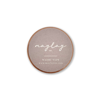 Round decorative washi tape from Maylay Co. called "I Am Grateful" in gold yellow, featuring minimalist packaging with the brand name in white cursive on a brown label. Below, it states WASHI TAPE along with a website URL. Ideal for scrapbooking projects.