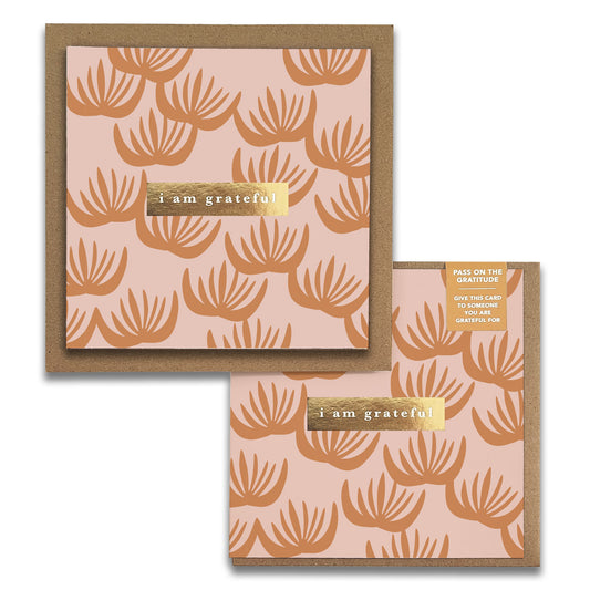 The Block Print Floral Gratitude Greeting Cards by Maylay Co. feature a premium quality design with a brown floral pattern on a peach background, elegantly centered with "I am grateful" on a gold label. These exquisite cards are paired with matching brown envelopes, showcasing the sophistication of high-end greeting cards.