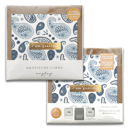 Two packs of Embroidery Gratitude Greeting Cards, featuring a paisley design in shades of blue and gray. The front text reads "I am grateful," while the back notes that two blank greeting cards are enclosed. Branded by Maylay Co., these thank you cards are perfect for passing on gratitude.