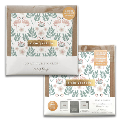 The Flamingos Gratitude Greeting Cards by Maylay Co. feature a design of floral and leaf patterns with the phrase "I am grateful" on the front. The packaging includes two greeting cards, perfect for expressing your heartfelt thanks and appreciation.