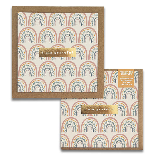 Two Happy Rainbows Gratitude Greeting Cards from Maylay Co. feature a brown and white arch pattern on a beige background. Each card includes a gold strip with the words "I am grateful" at the center, and the pack is labeled "Pass on the Gratitude.