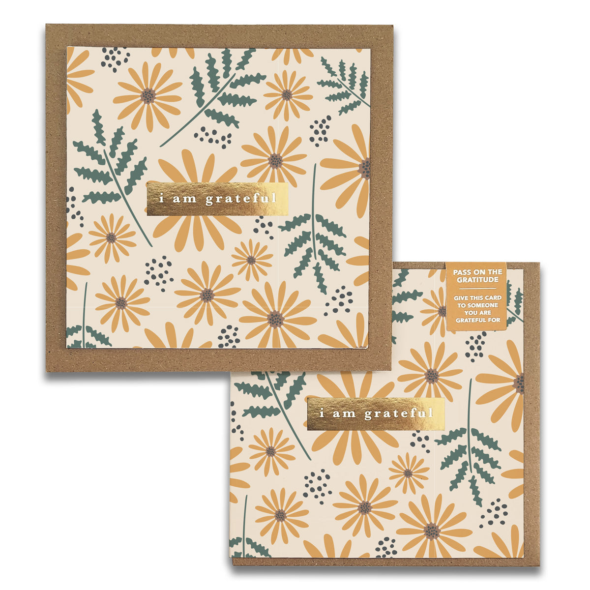 Introducing the Hello Daisy Gratitude Greeting Card by Maylay Co., designed with a charming floral pattern of yellow daisies and green leaves. The card includes a gold label with the message "I am grateful," inspiring you to express your appreciation by sharing it with others. It comes accompanied by a brown envelope, making it ideal for sending warm and heartfelt greetings.