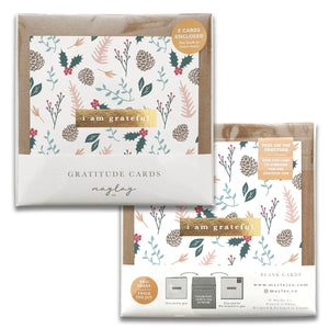 Introducing the "Holiday Foli Gratitude Greeting Cards" by Maylay Co., a beautifully designed set of two cards featuring gratitude-inspired themes with delicate floral and leaf patterns. The centerpiece of each card displays the words "I am grateful," accentuated with a gold foil stamp design. This package encourages spreading appreciation by gifting these elegant cards to others.