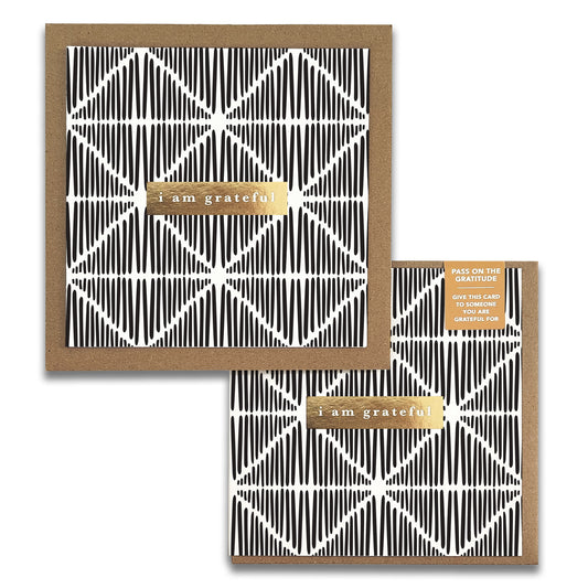 The Macrame Monochrome Gratitude Greeting Cards by Maylay Co. feature a sophisticated black and white geometric design with "i am grateful" elegantly scripted in gold on the front. This exquisite thank you card comes with an envelope that includes a small label for additional text.