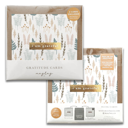 Two sets of Nature Walk Gratitude Greeting Cards by Maylay Co., showcasing nature-inspired designs with leaves and plants. Each pack includes greeting cards and envelopes, labeled with "I am grateful." One set is open to display both the front and back packaging, making it ideal for sending a heartfelt thank you message.