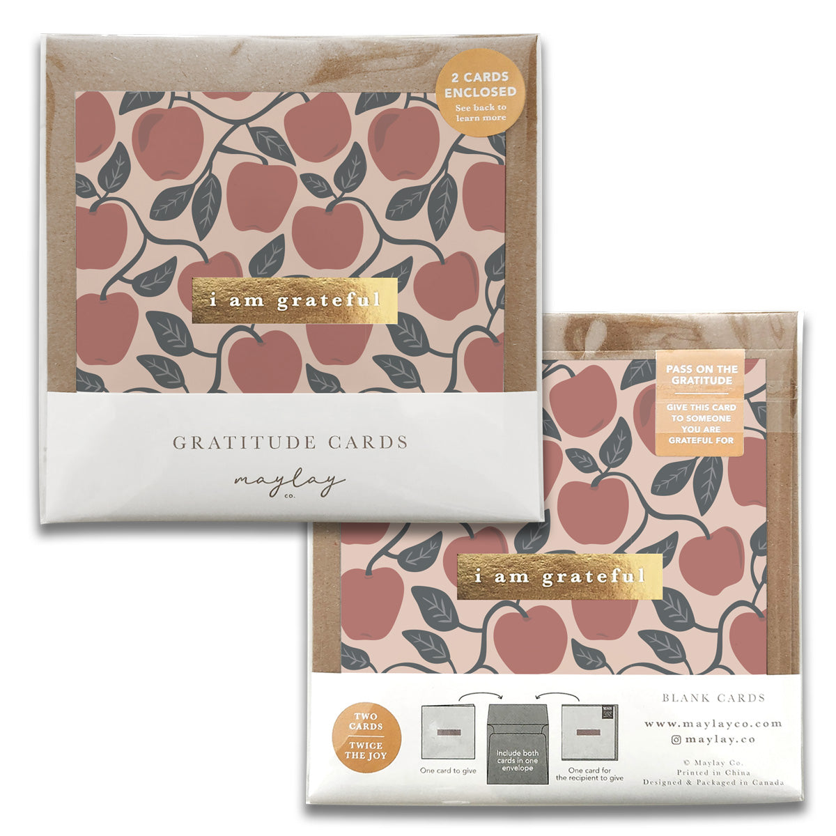 Two packs of Orchard Apples Gratitude Greeting Cards by Maylay Co., featuring a delightful peach and leaf design on a pink background. Each pack contains a card with the message "I am grateful." The packaging emphasizes that two cards are included, encouraging you to share your gratitude with others.