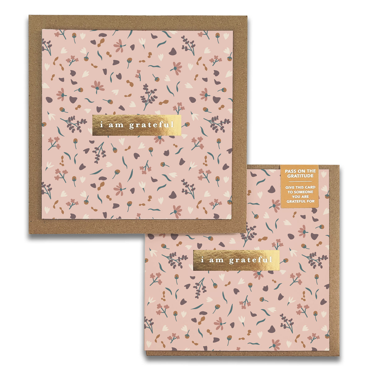 Two Sachet Gratitude Greeting Cards by Maylay Co. feature a delightful floral pattern set against a pink background. Each card is adorned with a gold-colored label that reads "I am grateful," complete with elegant brown borders, perfectly fusing elegance and mindfulness.