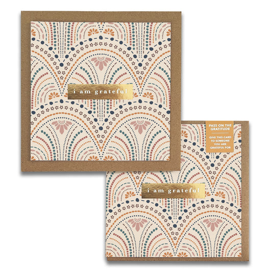 Two square "So Delicate Gratitude Greeting Cards" by Maylay Co. showcase intricate, patterned designs in shades of brown, orange, and blue. Each card prominently features "I am grateful" on a gold band. One card subtly peeks from behind the other, providing a heartfelt way to express your thanks.