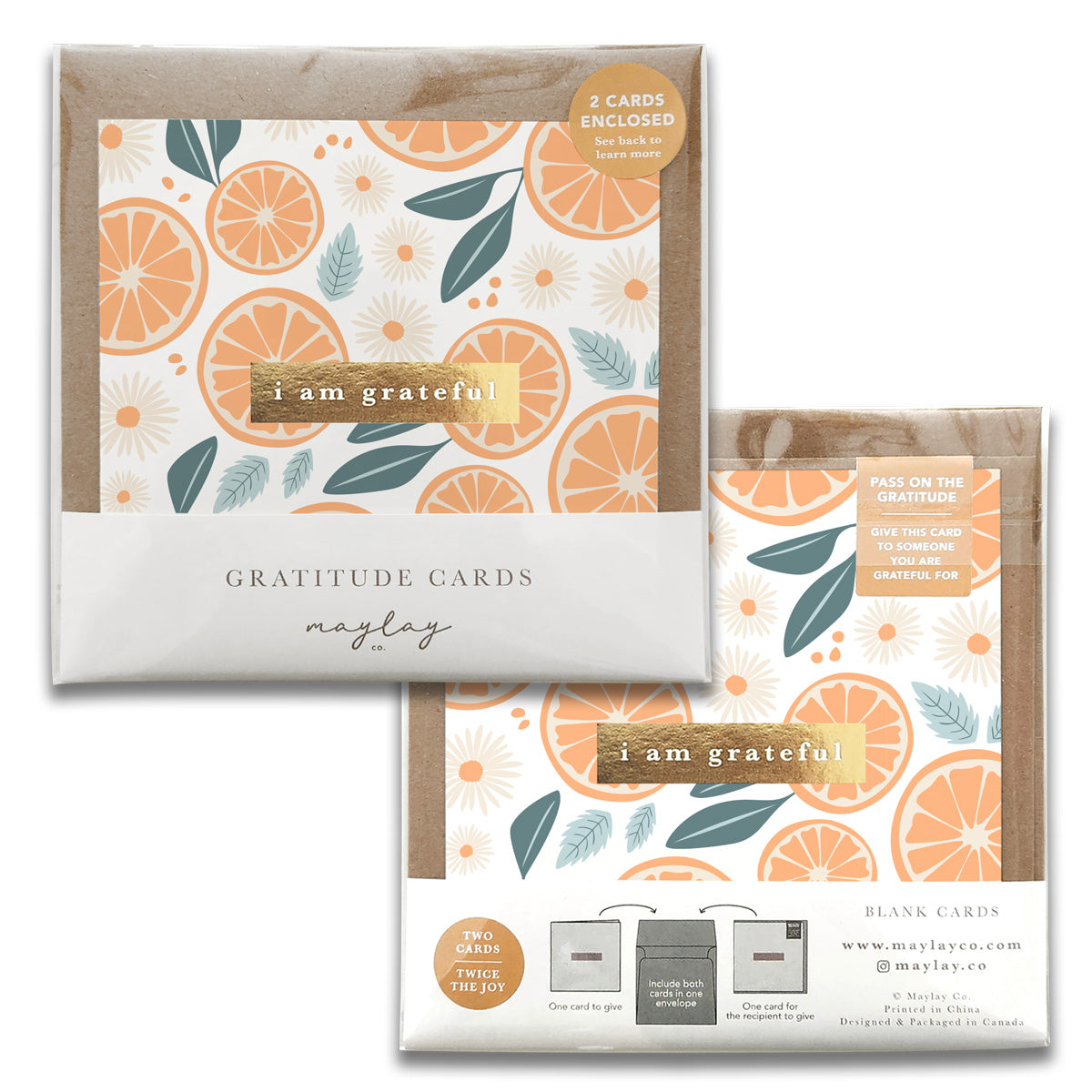 Two sets of Tang Gratitude Greeting Cards from Maylay Co. featuring a citrus and leaf design in orange and green tones. One set is labeled Gratitude Cards and the other is titled Thank You. Each package contains two blank greeting cards for expressing your gratitude.