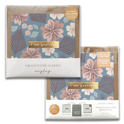 Presenting the Tropic Garden Gratitude Greeting Cards by Maylay Co., a set of elegantly designed cards featuring exquisite floral patterns and the phrase "I am grateful." Each package includes two cards, ideal for expressing heartfelt gratitude. For more information on these beautiful greeting cards, visit maylay.co.