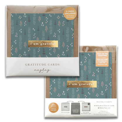 Explore our Wallflowers Gratitude Greeting Cards set, ideal for expressing thanks. Featuring a teal and white floral design, this set consists of two sophisticated greeting cards and envelopes. Each card carries a heartfelt message—"I am grateful" or "Pass on the gratitude"—with the Maylay Co. branding subtly displayed beneath.