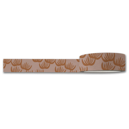 The Block Print Floral Washi Tape by Maylay Co. partially unspooled reveals a pattern of brown, stylized floral designs on a light brown background, making it perfect for journaling or scrapbooking projects.