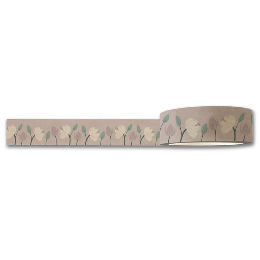 A roll of Enchanted Garden (Purple) Floral Washi Tape by Maylay Co. features a floral pattern with light green leaves and beige, cream, and mauve flowers on a neutral background. The tape is partially unrolled, displaying the continuous floral motif characteristic of Maylay Co.'s exquisite washi tapes.