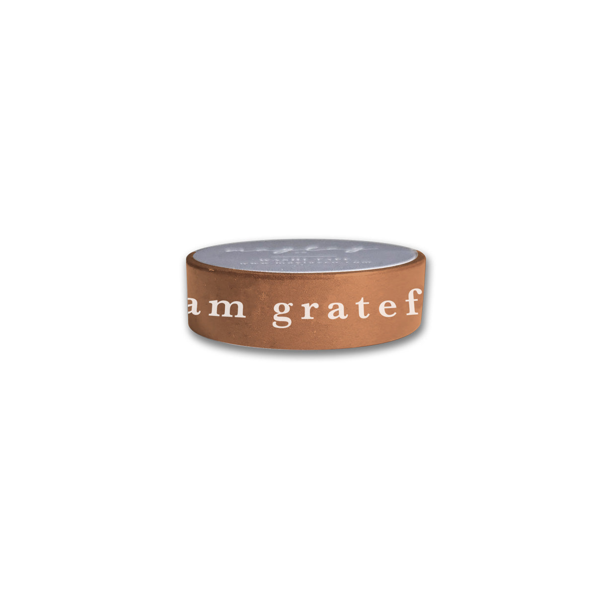 Introducing the "I Am Grateful" Washi Tape in a stylish terracotta brown from Maylay Co. This elegant tape features the inspiring phrase "I am grateful" meticulously inscribed in white letters, adding a touch of sophistication to your scrapbooking projects. Its flat gray top perfectly complements any decor and stands out beautifully against a plain white background.