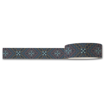 The Needlepoint Washi Tape by Maylay Co. is adorned with a geometric tribal pattern in teal, pink, yellow, and white set against a dark gray background. This design incorporates intricate shapes and lines to form a symmetrical motif ideal for scrapbooking projects.