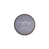 A circular washi tape from Maylay Co., named Needlepoint Washi Tape, features a gray label designed for scrapbooking. The text reads "Maylay Co." and "WASHI TAPE," while the website URL www.maylayco.com is printed below, making it a perfect addition to your decorative washi tape collection.