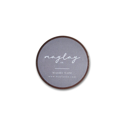 A round roll of decorative washi tape features a gray label on top, displaying the brand name Maylay Co. in white cursive along with the product name Embroidery Washi Tape and a website URL—perfect for scrapbooking projects.