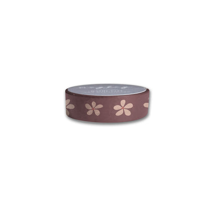 The Posy Floral Washi Tape by Maylay Co., featuring light pink flower patterns on a brown background, is displayed from the side against a plain white backdrop. Ideal for scrapbooking enthusiasts and craft lovers alike.