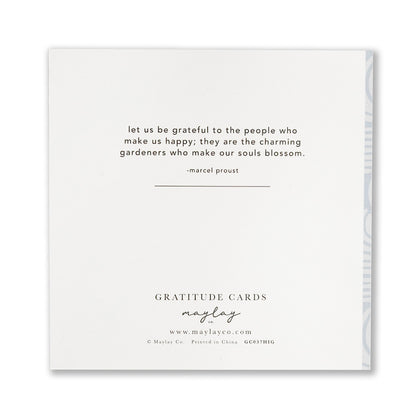 A greeting card from Maylay Co. called "High Tides Gratitude Greeting Cards" features a quote by Marcel Proust: "Let us be grateful to the people who make us happy; they are the charming gardeners who make our souls blossom." Below are the words Gratitude-Inspired Cards along with the website www.maylayco.com.