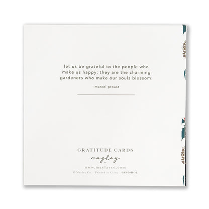 A Holiday Foli Gratitude Greeting Card from Maylay Co. showcases a gold foil stamp design on a white background, featuring a Marcel Proust quotation about appreciating those who bring us joy. The card is elegantly designed with a decorative border and includes Maylay Co.'s contact information at the bottom.